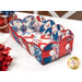 The completed Scalloped Basket, colored in red, white, and blue fabrics, staged on a white table with coordinating flowers and décor.