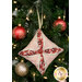 A closer look at the pink, cream, and red fabrics of the ornament, showing print colors and details.