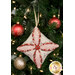 A closer look at the pink, cream, and red fabrics of the ornament, showing print colors and details.
