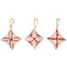 The three completed Cathedral Window Ornaments, colored in soft pink, cream, and red fabrics from the Christmas Magic collection, isolated on a white background. 