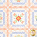 A head-on close up on the patchwork of the quilt, demonstrating fabric colors and print details.