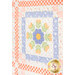 An angled close up on the patchwork of the quilt, demonstrating fabric colors and print details.