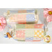 A top down shot of the mini charm bags, demonstrating fabric colors and zipper details.