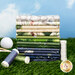 A stack of the fabrics included in the Tee Time collection, with grass and a sky and a golf ball and gold tees and thread.