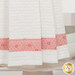 A super close up on the bottom of the towel, showing details on the towel texture and the fabric stripe.