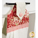 An angled close up on the top of the towel, demonstrating fabric colors on the prints and fabric button.