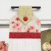 A super close up on the top of the towel, demonstrating fabric colors on the prints and fabric button.