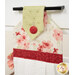 An angled close up on the top of the towel, demonstrating fabric colors on the prints and fabric button.
