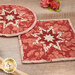 A close up on the red Folded Star Hot Pads.