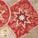 A top down close up on the folded star center of the red hot pad.