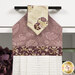 A close up on the top of the towel, demonstrating fabric colors on the prints and fabric button.