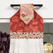 A close up on the top of the towel, demonstrating fabric colors on the prints and fabric button.