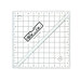 The 5.5" Half-Square Triangle Ruler in its packaging and isolated on a white background. 