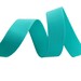 A teal ribbon, curled and resting on a flat surface.