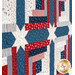 A close up on the patchwork of the quilt, demonstrating fabric colors, print details, and top quilting effects.