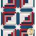 A close up on the patchwork of the quilt, demonstrating fabric colors, print details, and top quilting effects.
