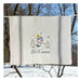 A decorative kitchen towel featuring a snowman.