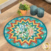 A round table topper with a bursting star design in vibrant southwest inspired fabrics from the Desert Dreams collection by Maywood Studio, staged on a wooden table with coordinating décor.