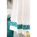 A super close up on the bottom of the towel, showing details on the towel texture and the fabric stripe.