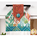 A super close up on the top of the towel, demonstrating fabric colors on the prints and fabric button.