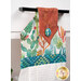 An angled close up on the top of the towel, demonstrating fabric colors on the prints and fabric button.