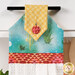 A super close up on the top of the towel, demonstrating fabric colors on the prints and fabric button.