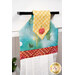 An angled close up on the top of the towel, demonstrating fabric colors on the prints and fabric button.
