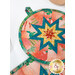 A close up on the round hot pad, showing details on the center folded star.