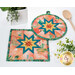 A closer look at the two Folded Star Hot Pads, demonstrating fabric color and print details.