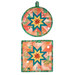 The two completed red Folded Star Hot Pads, one round and one square, staged on a white table with coordinating décor.