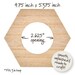 Back of hexagonal embroidery hoop frame with wood veneer finish.