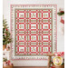 The completed Merry Mouse-mas Quilt, colored in gray, white, red, and green flannel fabrics from The Christmas Mouse collection by Northcott Fabrics, hung on a white shiplap wall and staged with coordinating decor.