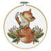The completed cross stitch fox holding a bird nestled in leaves and berries, framed in a wooden embroidery hoop.