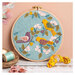 The completed Dawn Chorus Wool Mix Appliqué Kit in its hoop and surrounded by coordinating décor. 