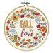 The completed cross stitch featuring the words "Fall in love" surrounded by fall themed motifs , framed in a wooden embroidery hoop.