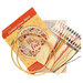 The contents of the Fall in Love cross stitch picture kit, including fabric, needle, hoop, floss, and the pattern.
