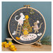 The completed Christmas with the Mouse Wool Mix Appliqué Kit in its hoop and surrounded by coordinating décor. 