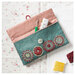 The completed Sewing Pouch open on a table surrounded by sewing notions. 
