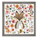 A framed and completed cross stitch project featuring a watercolor fox surrounded by colorful floral blooms and leaves.
