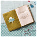 The completed Needle case open on a table surrounded by sewing notions. 