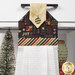A super close up on the top of the towel, demonstrating fabric colors on the prints and fabric button.