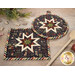 A closer look at the two Folded Star Hot Pads, demonstrating fabric color and print details.