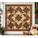 The completed Cactus in the Cabin quilt, colored in red, cream, sage green, and soft black metallic fabrics from the Merry Manor Metallic 2025 collection from Moda Fabrics. The quilt is hung on a cream wall and staged with coordinating holiday decor.