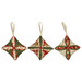 The three completed Cathedral Window Ornaments, colored in cream, green, and red fabrics from the Merry Manor Metallic 2025 collection, isolated on a white background. 