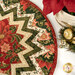 A top down shot of the topper, demonstrating fabric color and print details on the folded points as well as the binding.