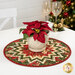 A lifestyle shot of the topper with a poinsettia in white pot, staged on a white table with coordinating glasses and décor.