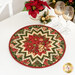 The completed topper, colored in red, cream, and green metallic fabrics from the Merry Manor Metallic 2025 collection from Moda Fabrics, staged on a white table with coordinating glassware and décor.