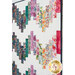 A close up on the quilt showing details on the fabric colors, prints, and top quilting details.