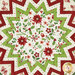 A top down shot of the topper, showing fabric and color details on the poinsettia and holiday themed prints.