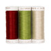 Three spools of red, green, and cream thread that coordinate with the topper, isolated on a white background. 
